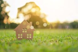 Closed,Up,Tiny,Home,Model,On,Green,Grass,With,Sunlight